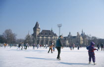 Ice skaters on outdoor rink.