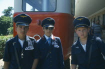 Three Hungarian boys in Pioneers railway uniform.