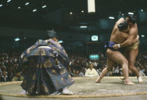 Grand Sumo wrestling match with referee in ritual dress