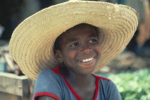 Smiling boy wearing wide brimmed straw hat.Brasil Brazil