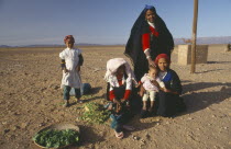 Tribal woman and children in desert area.