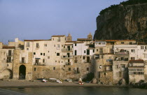 Town houses on edge of water with huge rock behind once the site of a Temple of Diana.
