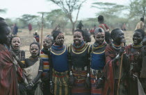 Young Karamojong girls with giraffe markings painted on their faces in preparation for dance during Akiudakin cattle bleeding ceremony.Pastoral tribe of the Plains Nilotes group related to the Masi