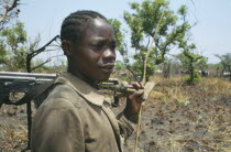 Portrait of a Karamojong tribesmen with an automatic weapon guarding cattle near Lira against border raids from the Turkana people of KenyaPastoral tribe of the Plains Nilotes group related to the Ma...