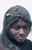 Portrait of Afar woman with verses of the Koran tied around her head to cure migraine.Cushitic speaking pastoral nomads aka Danakil and Adali