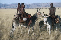 Himba group on donkeys. Semi nomadic pastoral people related to the Herero and speaking the same language