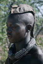 Kaokoland.  Portrait of Himba man.  Cloth covering head denotes that he is married. Semi nomadic pastoral people related to the Herero and speaking the same language