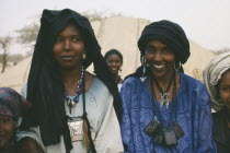 Head and shoulders portrait of two Tuareg women near Tanout wearing typical jewellery and indigo coloured head dresses.Nomadic muslim minority of Berber origin Moslem Colored Coloured