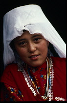 Head and shoulders portrait of Kirghiz girl.