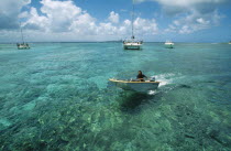 Man riding speedboat on turquoise sea