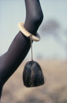 Detail of ivory bracelet worn by Dinka woman from the Agar tribe decorated with tassle made from cattle or buffalo hair.