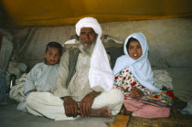 Portrait of nomad family in their tent.
