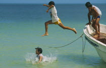 Gulf of Mexico.  Children jumping from fishing boat into sea.