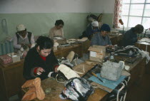 Lesnoe.  Workers in factory making boots and hats from reindeer skin.