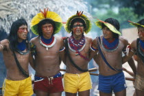 Xikrin Indian men wearing feathered head dresses dancing.Brasil Kayapo Brazil Kaiapo Mebengorke