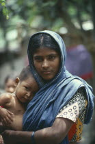 Young mother holding baby.