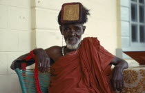 Ashanti tribal elder wearing gold head tablet to denote  status and power.