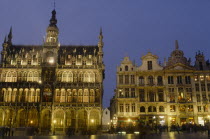 The Grand Place illuminated at night busy with people.