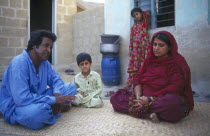Family sitting in the courtyard of their home.