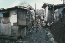 Smokey Mountain slum area.  Children in narrow alleyway between dilapidated shacks.
