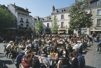 Tours Place Plumereau with view over people eating at tables and buildings behind.