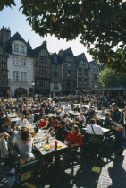 Tours Place Plumereau with view over lots of people eating at tables.
