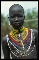 Young Dinka girl wearing multi stranded necklace made from tiny coloured beads Colored