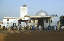 Crowds at exterior to mosque like building at the begining of the Fete Foumbam to mark the end of Ramadam.