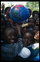 School children with globe made by Pamet paper making project which produce fair trade goods from recycling everything from newspaper to elephant dung.