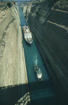 Cruise ship being towed by a tug through the canal