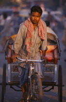 Rickshaw driver cycling on the road in the early morning
