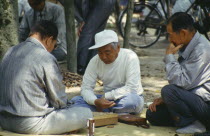 Men playing game on a mat in the Peace Park