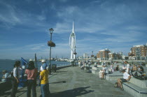 Spice Island. Groups of people looking towards the Spinnaker Tower.