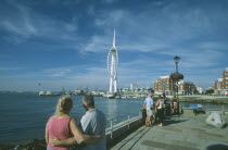 Spice Island. A couple arm in arm looking towards the Spinnaker Tower.