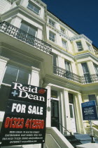 Real Estate For Sale signs outside Regency style properties.  Estate Agent