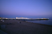 England, East Sussex, Brighton, Pier illuminated at night.