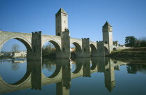 Pont Valentre. Bridge with two towers and it s reflection in the river.