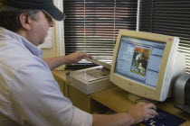 Man using a flatbed scanner