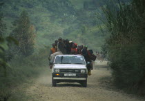 Uganda, Transport, Car with people overloaded on the back.