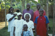 Uganda, Family, Husband wife and six children dressed in Sunday best.
