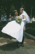 Wedding in El Monticulo. Groom lifting up Bride.