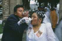 Wedding in El Monticulo. Bride and Groom interlocking arms and drinking. Money attached to Bride s dress.