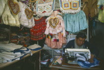 Costume maker for Oruro Carnival. Man working on his sewing machine.