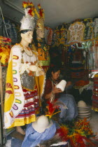 Costume maker for Oruro Carnival. Woman sat  holding large spool of thread.