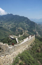 View of the Great Wall winding through the mountains into the distance. People walking on the wall  rebuilt 1567 to 70