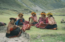 Local Quechuan women sat on grass  wearing traditional dress. Cuzco  Sacred Valley  Andes Cuzco  Sacred Valley  Andes