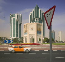 A car on the roundabout on The Corniche  with a road sign in the foreground.Travel  Automobile