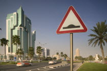 A road sign on The Corniche  palm trees either side of the road.Travel  Holidays  Tourism