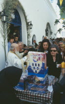 Akrotiri. Annual Festival of Ayios Epiphanios. Congregation collecting wine and bread after the procession.may 12th