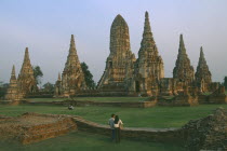 Wat Phanan Choeng with visiting Thai couple in foreground looking towards the ruins.Unesco World Heritage site